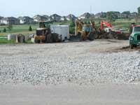 Picture of a large gravel drive with construction equipment.